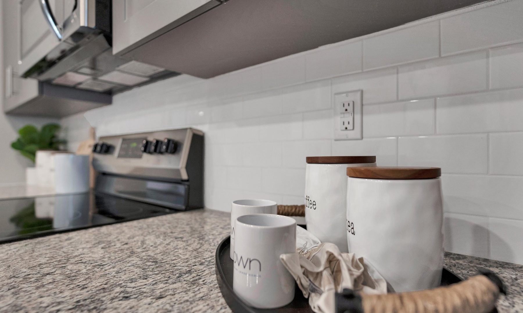 kitchen with granite countertops and stainless steel appliances at The Town Arlington