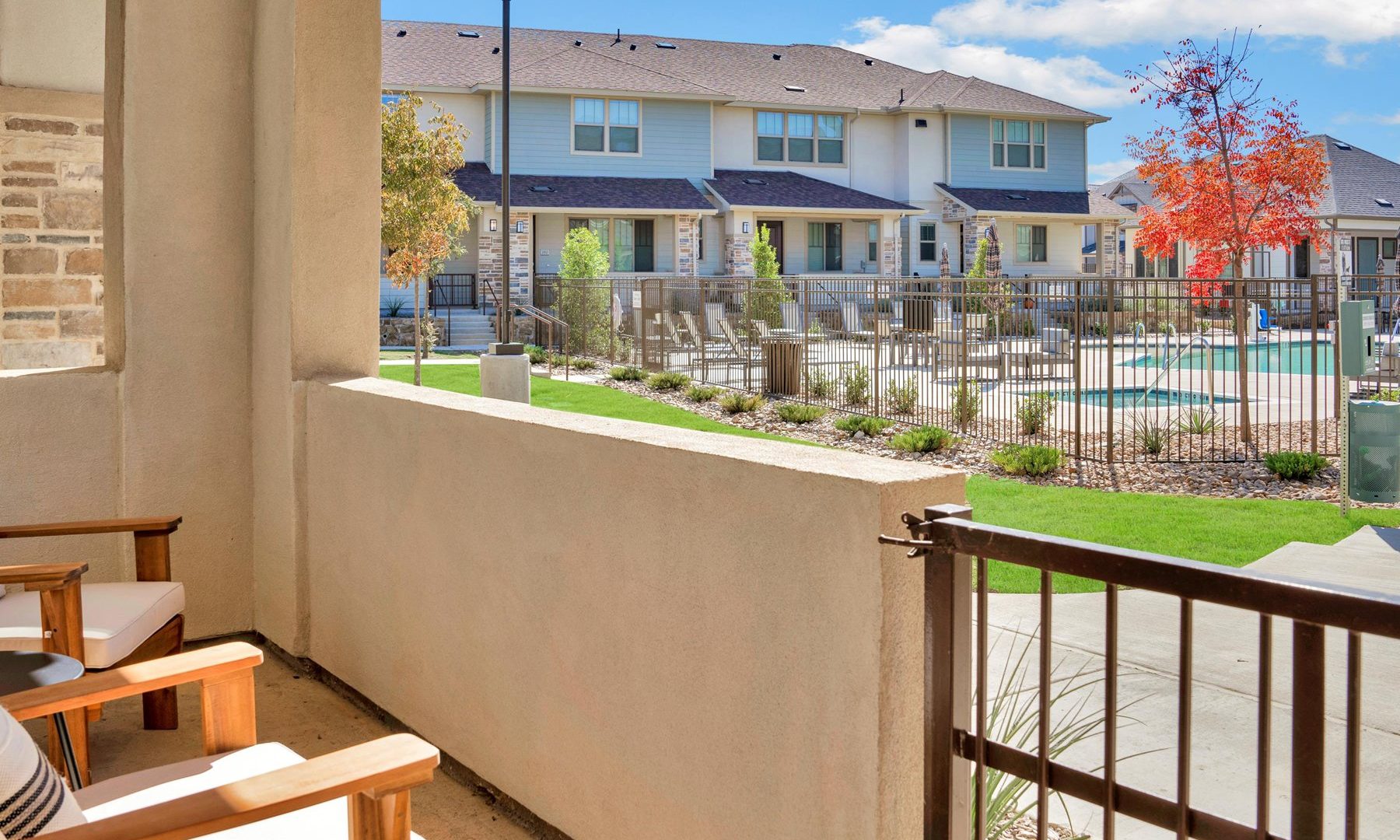 a balcony with chairs and a pool in the background at The Town Arlington