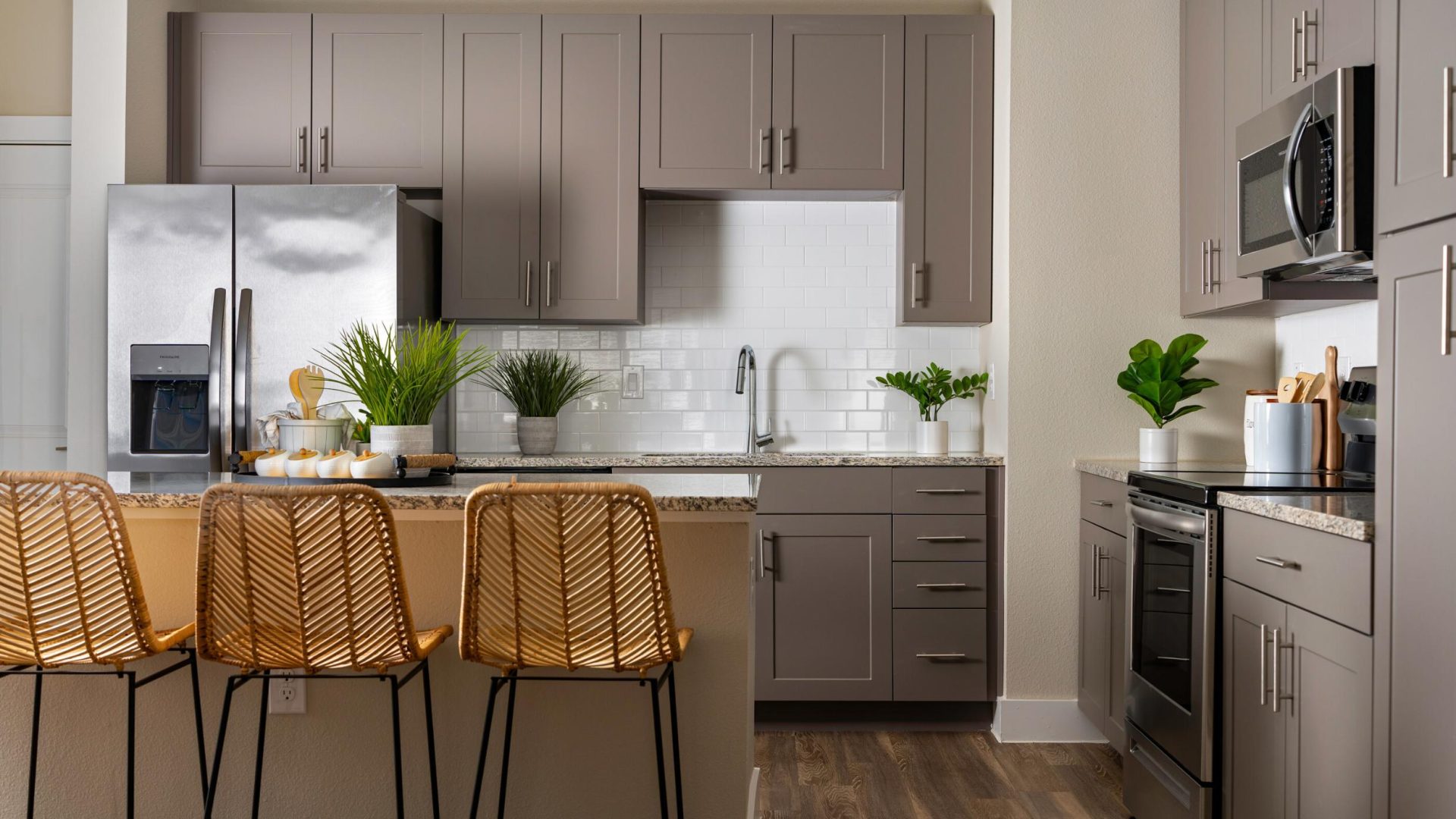 a kitchen with a large island and bar stools at The Town Arlington