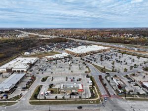 an aerial view of a shopping center with parking lots at The Town Arlington