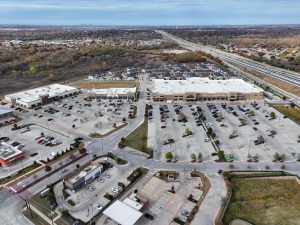 an aerial view of a shopping center with parking lots at The Town Arlington